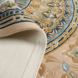 Close-up of Celestia hand-tufted luxury rug with intricate blue, gold, and beige floral pattern