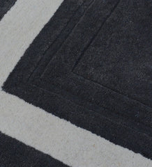 Luxury hand-tufted wool rug featuring grey center and ivory border