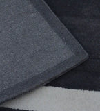 Minimalist charcoal and ivory rug with embossed rectangle detail