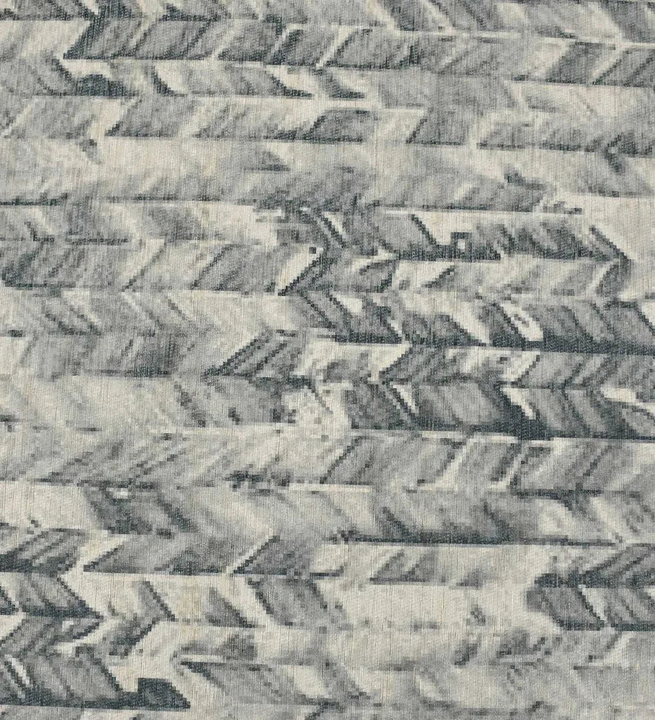 Low-profile modern rug in deep charcoal tones.
