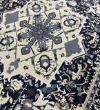 Close-up of luxury handwoven classic medallion rug with intricate floral patterns in beige, gray, and black