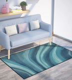 Modern living room with pastel blue sofa and abstract coastal blue ocean rug on light wood floor