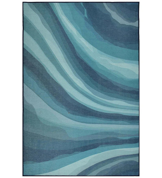 Coastal blue abstract ocean rug with wave-inspired design.