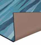 Coastal blue modern abstract handwoven rug with layered brushstroke design, folded corner showing non-slip backing