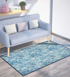 Coastal chevron pattern watercolor style rug in shades of blue under light blue sofa with pillows in modern living room