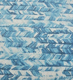 Close-up of a handwoven coastal chevron luxury rug in watercolor blue tones