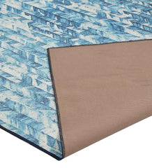 Coastal style rug with blue and beige chevron stripes.