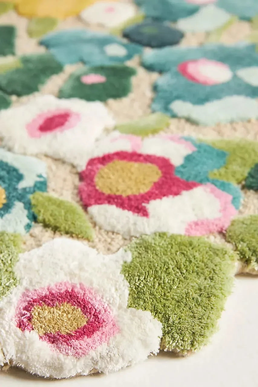 Colorful floral-patterned rug with green, pink, and white flowers.