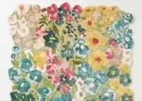Handwoven colorful floral rug with vibrant flowers in blue, pink, yellow, and green, luxury home decor