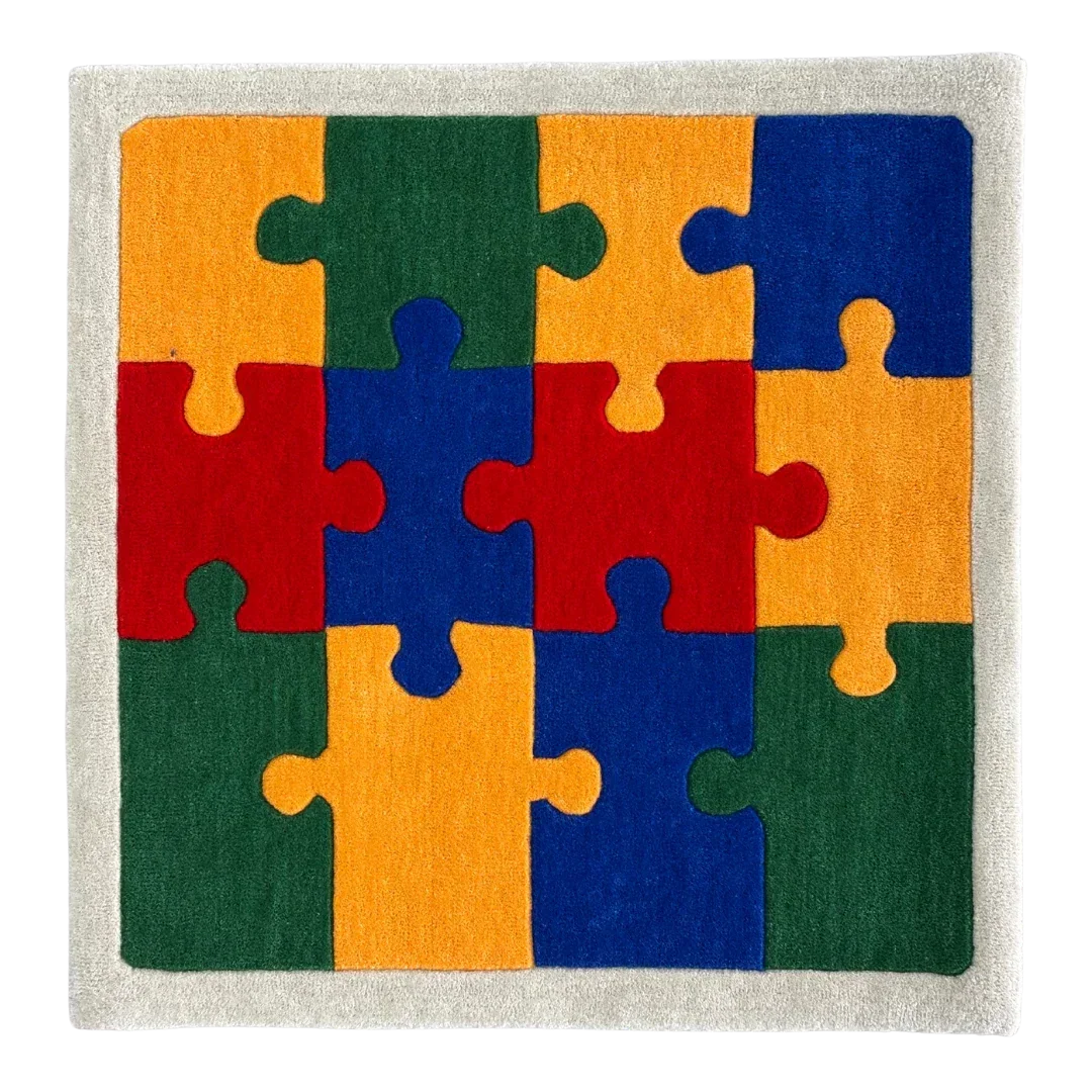 Colorful puzzle piece rug with red, orange, green, and blue pieces on a neutral background