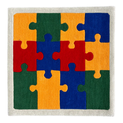 Colorful puzzle piece rug with red, orange, green, and blue pieces on a neutral background