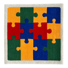 Colorful puzzle piece rug with red, orange, green, and blue pieces on a neutral background