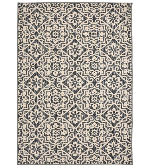 Cream geometric floral patterned rug with gray and beige details.
