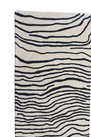Contemporary abstract area rug with black line art on cream background.