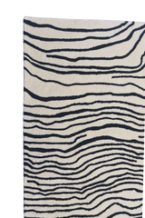 Contemporary abstract area rug with black line art on cream background.