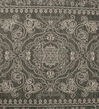 Dark ornate rug with intricate beige floral and geometric patterns, luxurious handwoven design