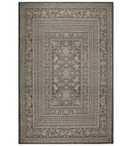 Dark ornate handwoven rug with intricate floral and geometric patterns in neutral tones
