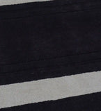 Luxury wool rug featuring plum background and ivory border