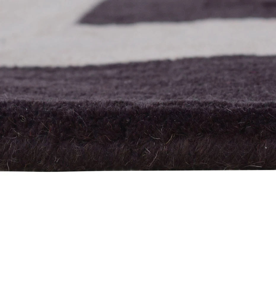 Geometric border rug in plum and ivory hand-tufted wool
