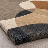 Close-up of beige, brown and charcoal geometric pattern on hand-tufted wool area rug