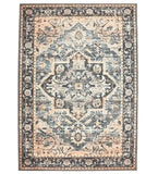 Distressed vintage-style area rug with intricate floral and geometric patterns in muted black, peach, and cream