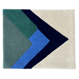 Abstract geometric luxury handwoven rug with overlapping mountain peak shapes in earth tones and blue