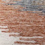 Luxury hand-tufted rug with abstract zigzag in muted colors.