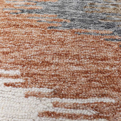 Luxury hand-tufted rug with abstract zigzag in muted colors.