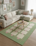 Emerald green color block hand-tufted area rug styled in a living room, adding a bold, modern, and luxurious accent to the space