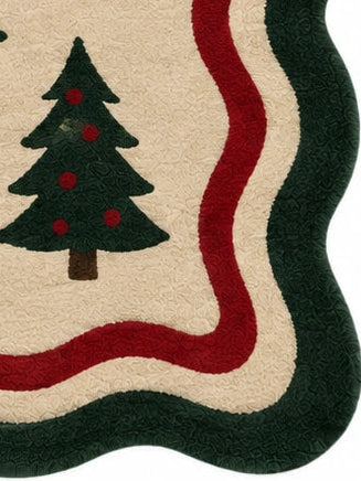A rectangular holiday-themed rug with a scalloped border, featuring brown leaping reindeer with red scarves, dark green Christmas trees, gold stars, and red holly motifs on a beige background.