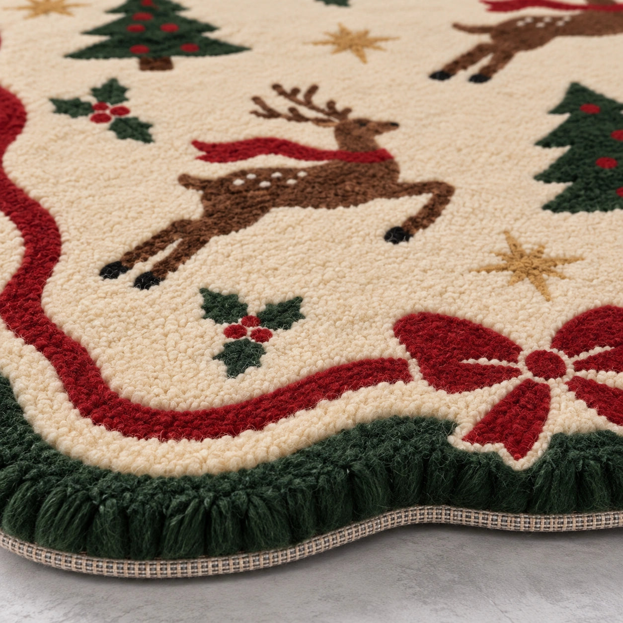A close-up of a tufted area rug with a Christmas theme, featuring brown reindeer with red scarves, green Christmas trees, red bows, holly, and gold stars on an off-white background.
