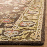 Close-up of a floral hand-tufted luxury rug with intricate beige, brown, and olive green patterns on wooden floor