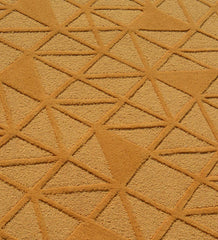 Handcrafted wool rug with embossed geometric texture in gold