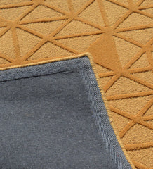 Modern gold rug with bold geometric triangle motif