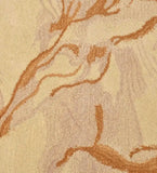 Close-up of vibrant abstract rug with gold and beige swirling patterns and textured fibers
