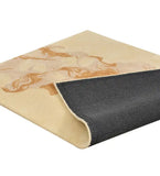 Gold and beige abstract patterned rug with black backing folded at corner