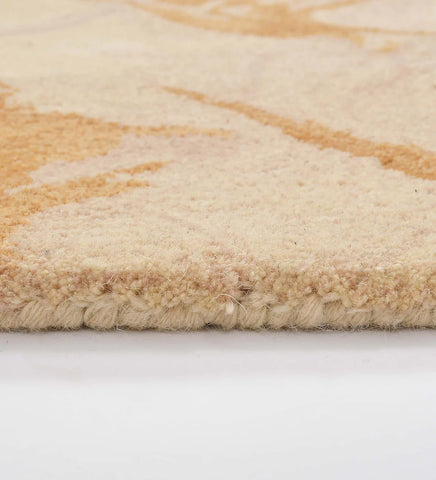 Contemporary wool rug with bold gold and beige abstract design.
