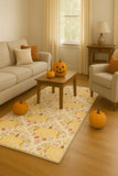 Cozy living room with beige sofa, armchair, floral pumpkin fall rug, wooden coffee table, and pumpkins