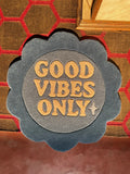 Flower-shaped decorative rug with 'GOOD VIBES ONLY' text in beige on blue background, luxury handmade style