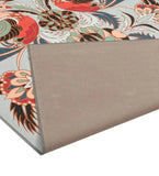 Luxury handwoven floral rug with vibrant red, green, and blue patterns and a folded beige backing