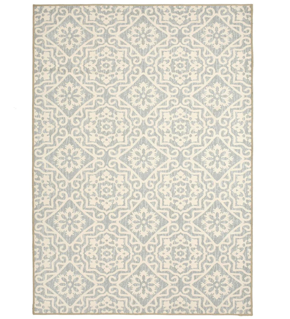 Gray geometric floral patterned rug with cream detailing.