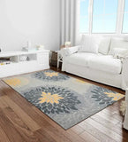 Modern gray floral rug with yellow accents in bright living room with white sofa and wooden floor