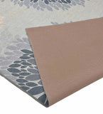 Gray modern floral area rug with blue petal patterns and beige underside, luxury handwoven design