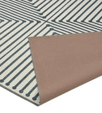 Gray and white modern geometric patterned rug with corner folded showing brown non-slip backing