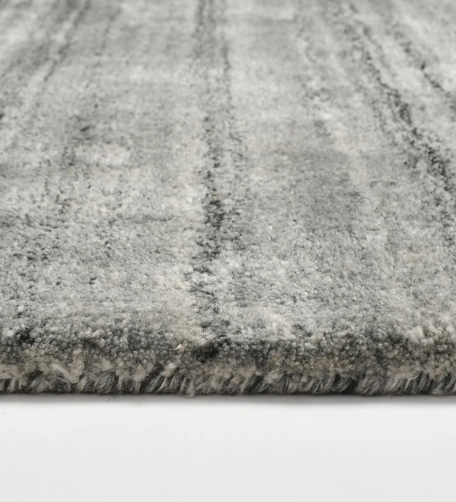 Minimalist grey hand-tufted rug with subtle striped detailing