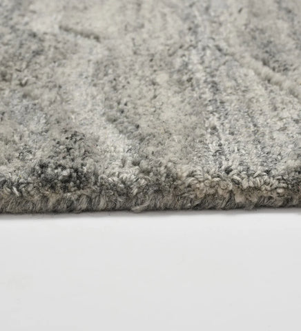 Textured grey wool rug inspired by stone and water patterns