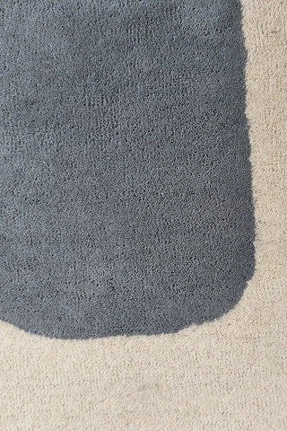 Artistic area rug with overlapping geometric forms and sketch outlines.