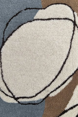 Contemporary hand-tufted rug with free-form organic shapes.