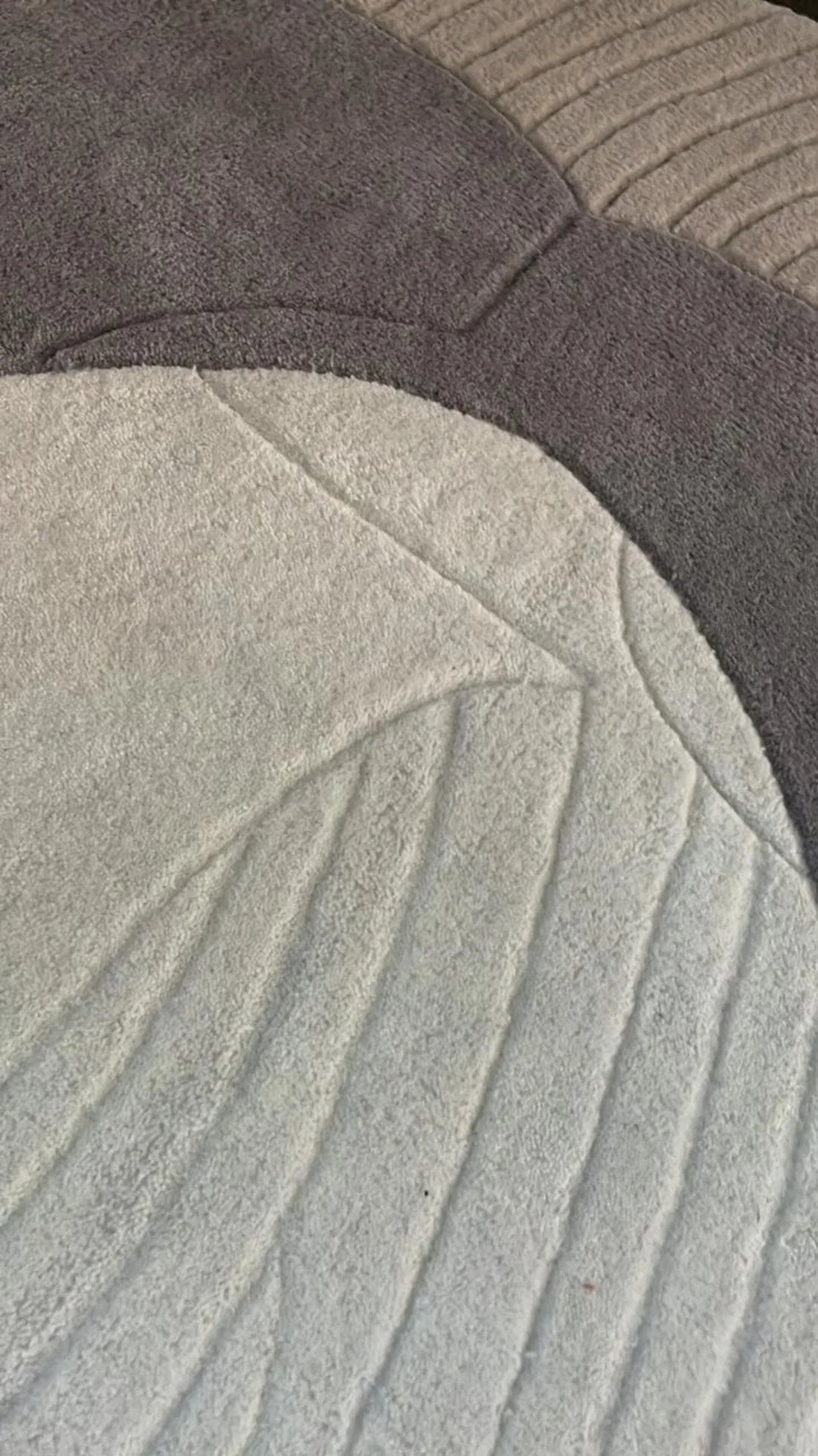 Abstract sculpted rug for modern living room decor.