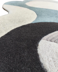 Handcrafted premium wool rug in neutral gray tones.